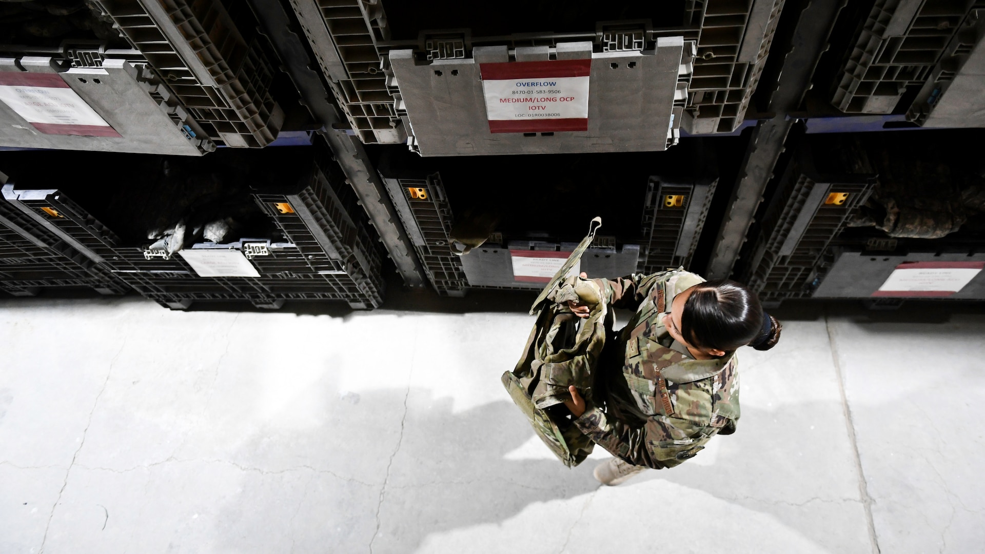 Airman 1st Class Brianna Renninger, 386th Expeditionary Logistics Readiness Squadron expeditionary theater distribution center journeyman, picks a piece of body armor from a bin at Ali Al Salem Air Base, Kuwait, Aug. 13, 2019. Theater distribution facilities stock items in theater for forward-deploying Airmen. Having the stock in country eliminates the need to transport the additional weight and mission-essential gear during military movements. (U.S. Air Force photo by Staff Sgt. Mozer O. Da Cunha)