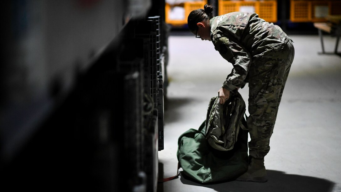 Senior Airman Katilyn Andrew, 386th Expeditionary Logistics Readiness Squadron expeditionary theater distribution center journeyman, packs a mobility bag with body armor components at Ali Al Salem Air Base, Kuwait, Aug. 13, 2019. Theater distribution facilities stock items in theater for forward-deploying Airmen. Having the stock in country eliminates the need to transport the additional weight and mission-essential gear during military movements. (U.S. Air Force photo by Staff Sgt. Mozer O. Da Cunha)