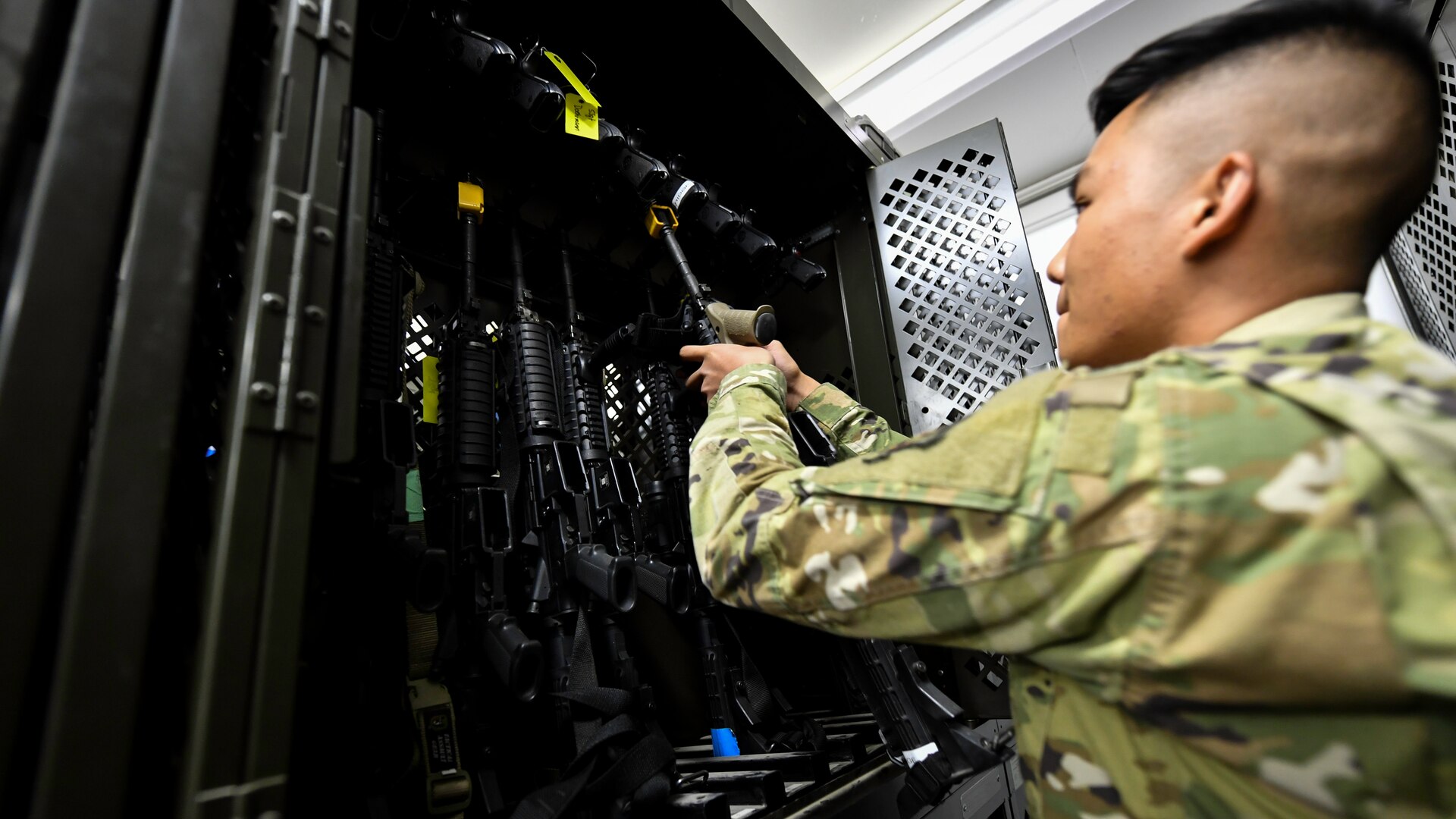 Airman 1st Class John-Alfred Cordora, 386th Expeditionary Logistics Readiness Squadron expeditionary theater distribution center journeyman, inspects the serial number on a M4 carbine at the ETDC armory facility on Ali Al Salem Air Base, Kuwait, Aug. 13, 2019. Theater distribution facilities stock items in theater for forward-deploying Airmen. Having the stock in country eliminates the need to transport the additional weight and mission-essential gear during military movements. (U.S. Air Force photo by Staff Sgt. Mozer O. Da Cunha)