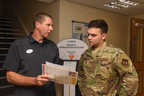 James Sarosi, 100th Force Support Squadron education services specialist, speaks with Airman 1st Class Brandon Lemon, 100th Logistics Readiness Squadron ground transportation apprentice, about degree options at RAF Mildenhall, England, Aug. 15, 2019. Counselors at the education office assist Airmen in realizing the benefits and opportunities available to them as military members. (U.S. Air Force photo by Airman 1st Class Joseph Barron)