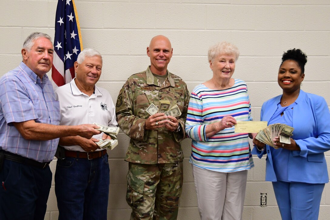 From left to right, Ron Durant and Dallas Godfrey, Corn and Sausage Roast chairmen; Brig. Gen. Richard Kemble, 94th Airlift Wing commander; Nancy Black, Dobbins Thrift Shop manager; and Angela Pedersen, 94th Airman and Family Readiness director, pose for a photo at Dobbins Air Reserve Base, Ga., Aug. 15, 2019.