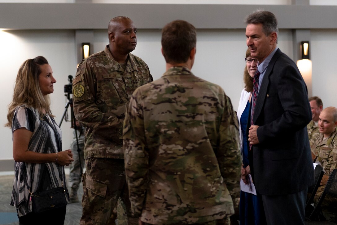 Ron and Marge Weber, right, parents of Capt. Mark Weber, speak with attendees of a dedication ceremony Aug. 16, 2019, at Moody Air Force Base, Ga. The event room in building 400 at Moody was dedicated to and renamed in honor of Capt. Mark Weber, 38th Rescue Squadron combat rescue officer. Weber, a Texas native, was killed in an HH-60G Pave Hawk crash in Anbar Province, Iraq, March 15, 2018, while supporting Operation Inherent Resolve. (U.S. Air Force photo by Airman 1st Class Taryn Butler)