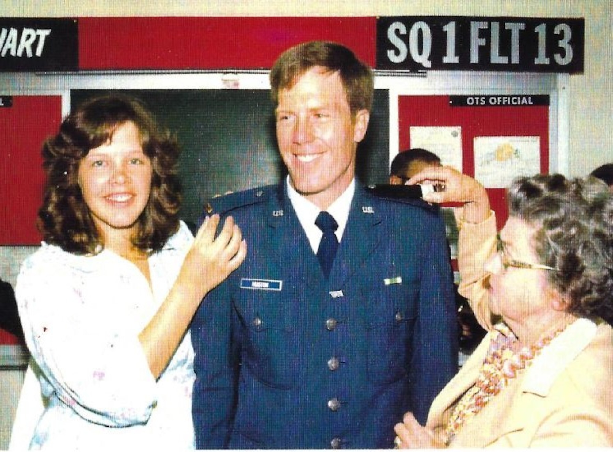 Lt. Col. Kenneth Huston getting pinned on by Elisabeth Silver, Huston widow, and Lois Marriott, Elisabeth's grandmother, during Officer Training School graduation. (Courtesy Photo)
