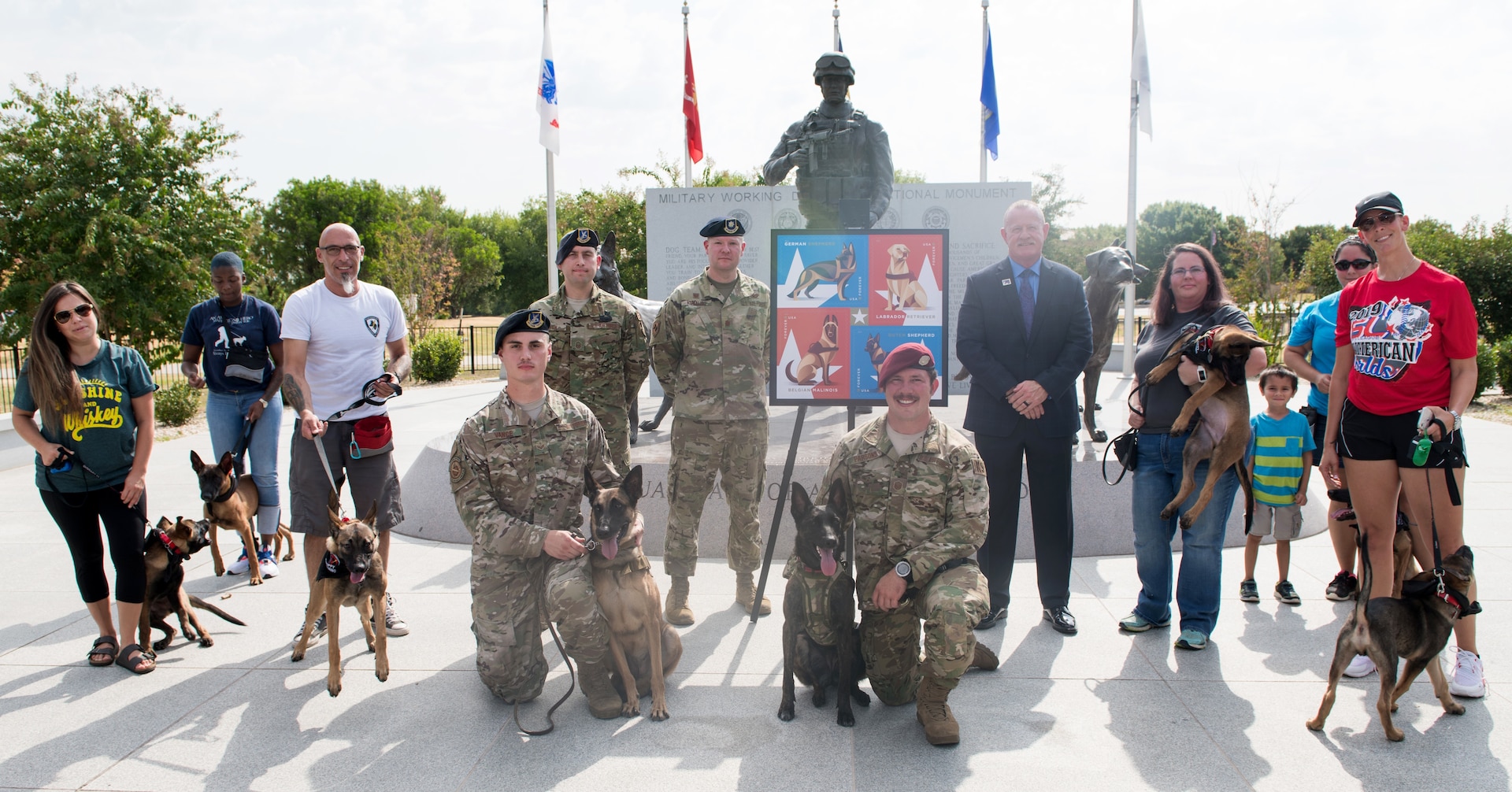 U.S. Air Force members, Robert Carr (center), Post Master of San Antonio, and local volunteers of the K-9 program pose for a photo during the Military Working Dog Stamp ceremony Aug. 15, 2019, at Joint Base San Antonio-Medina Annex. The stamp honors dogs who have served in the U.S. armed forces since the U.S. Army created the War Dog Program K-9 Corps and began training man’s best friend in March 1942.