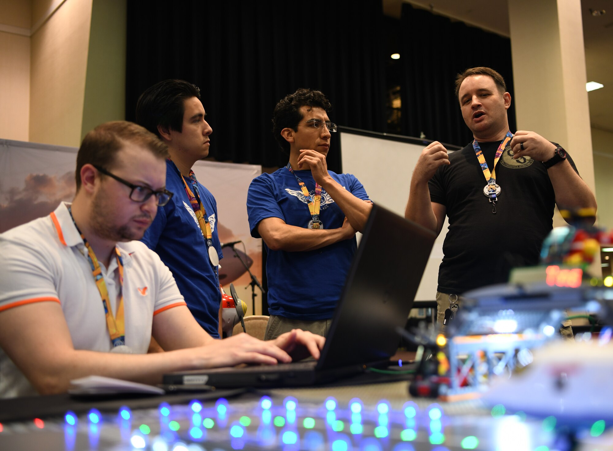 Cody Jackson (right), 90th Cyberspace Operations Squadron constructive modeler, hosts cyber students for a “Bricks in the Loop” presentation at DEF CON 27 Hacking Conference in Las Vegas, Aug. 9, 2019. “Bricks in the Loop” mimics an Air Force installation to simulate real-world cyber systems in training cyber operators. (U.S. Air Force photo by Tech. Sgt. R.J. Biermann)