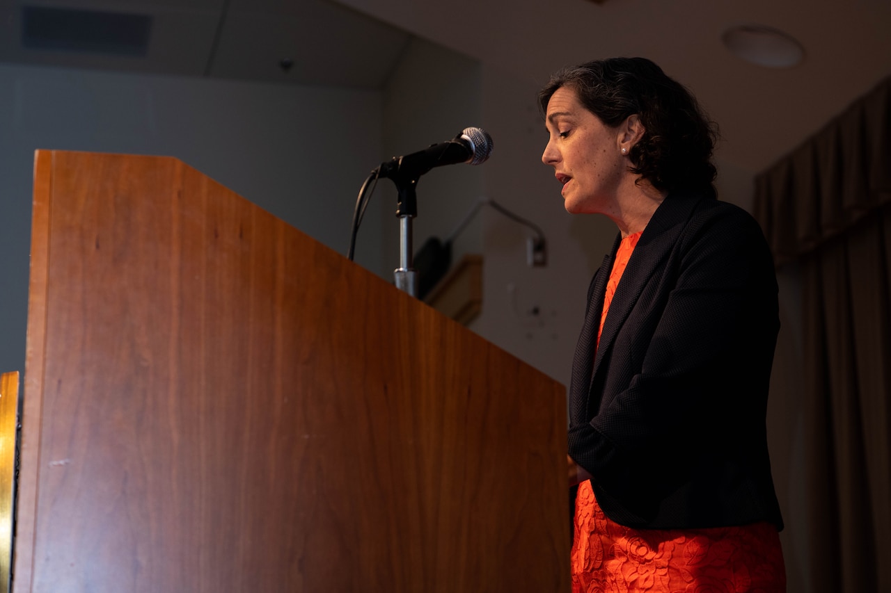 Woman speaks to an audience.