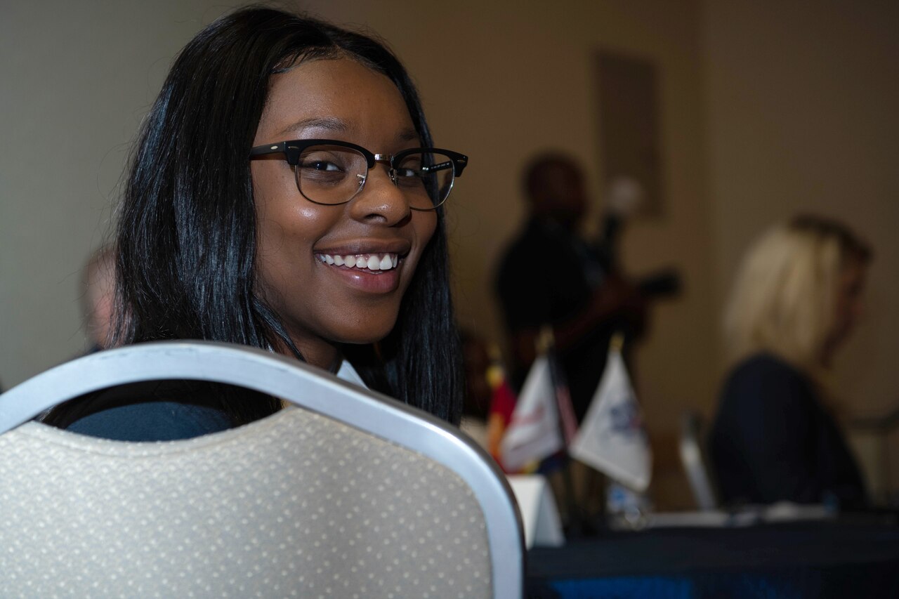 A girl smiles at the camera.