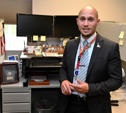 Rey Febo discusses strategic planning for capabilities and risks with a coworker at Wright-Patterson Air Force Base, August 13 2019.  (U.S. Air Force photo / Darrius A. Parker)