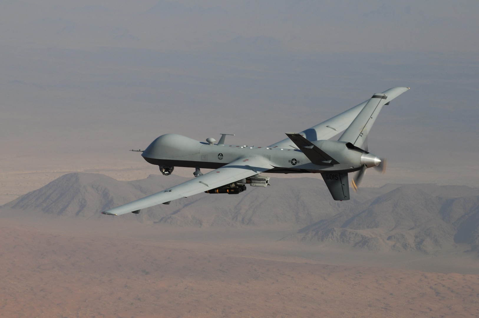 An MQ-9 Reaper, armed with GBU-12 Paveway II laser guided munitions and AGM-114 Hellfire missiles, piloted by Col. Lex Turner flies a combat mission over southern Afghanistan.