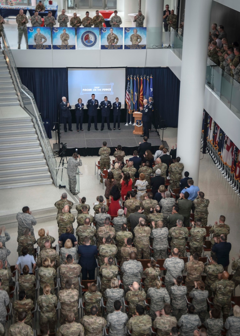 U.S. Airmen representing the four Air National Guard 2019 Outstanding Airmen of the Year receive a standing ovation from the audience during an award ceremony at the Air National Guard Readiness Center at Joint Base Andrews, Md., Aug. 15, 2019. This award ceremony was one event held during the 2019 Focus on the Force Week, a week-long series of events dedicated to enhancing enlisted corps growth and development through the collaboration of ANG leadership and the four OAY honorees. (Air National Guard photo by Staff Sgt. Morgan R. Lipinski)