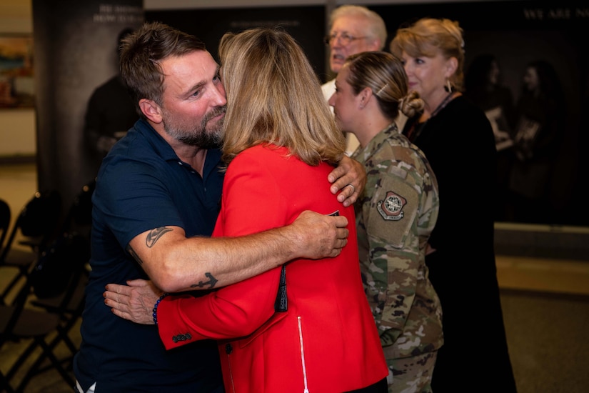 A man and woman hug.