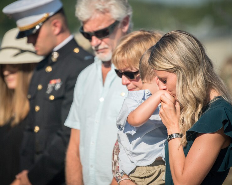 Alyssa Kidd comforts Beckham Kidd while the family comes together for the renaming of the Weapons Load Training facility at Barksdale Air Force Base, Louisiana, to the Kidd Weapons Load Training facility in honor of the late Tech. Sgt. Joshua L. Kidd Aug. 16, 2019.