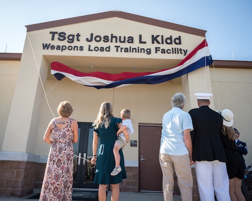 The Kidd family, friends and Airmen of the 2nd Bomb Wing gather for the renaming of the Weapons Load Training facility at Barksdale Air Force Base, Louisiana, to the Kidd Weapons Load Training facility in honor of the late Tech. Sgt. Joshua L. Kidd Aug. 16, 2019.