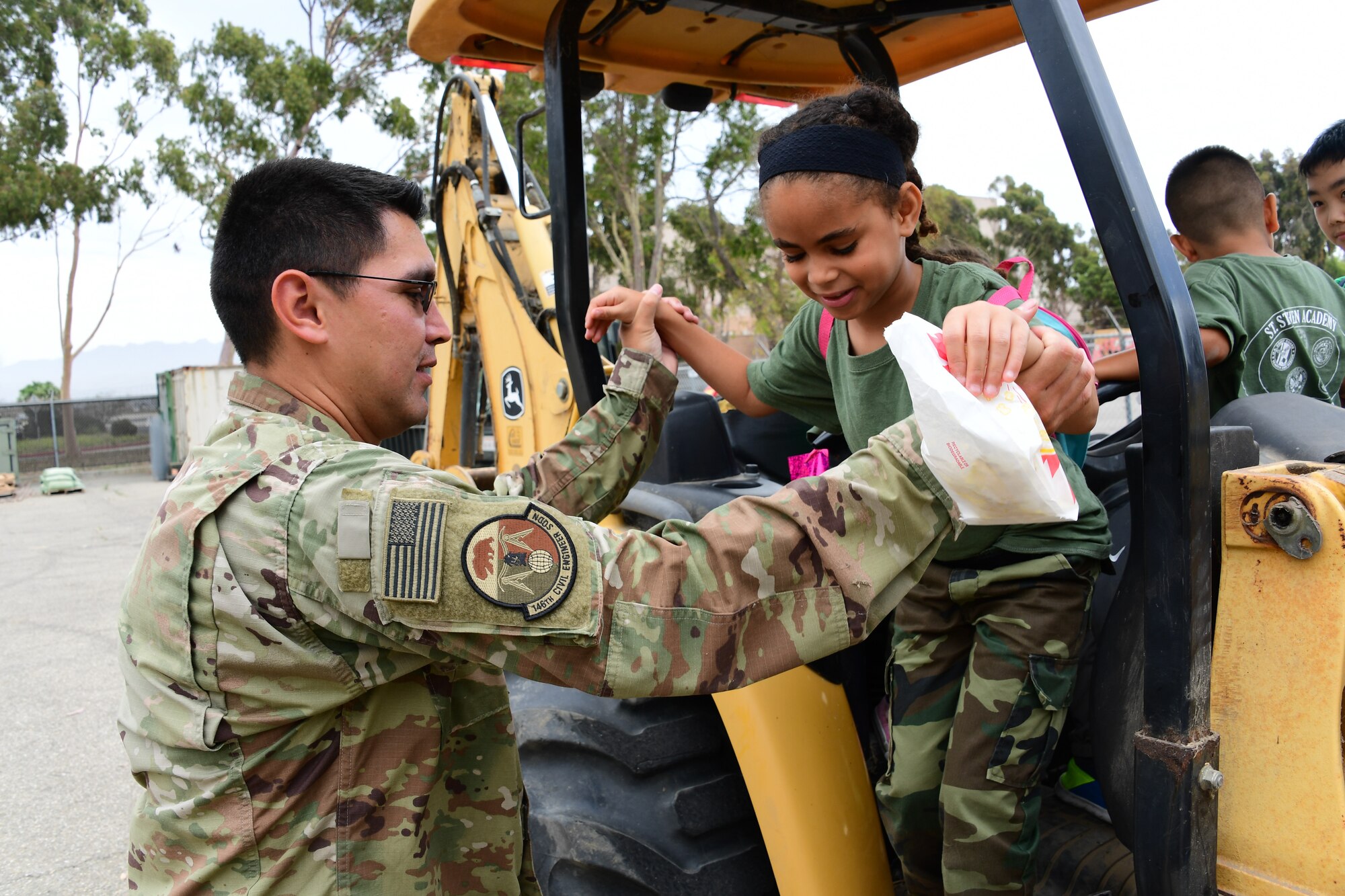 U.S. Air National Guard Staff Sgt. Guillermo Diaz Garcia provides a tour of heavy equipment used by the 146th Civil Engineer Squadron to a group of children attending students attending a summer camp with St. Stephen’s Academy at the Channel Islands Air National Guard Station, Port Hueneme, CA. July 25, 2019. (U.S. Air National Guard photo by Tech. Sgt. Nieko Carzis)