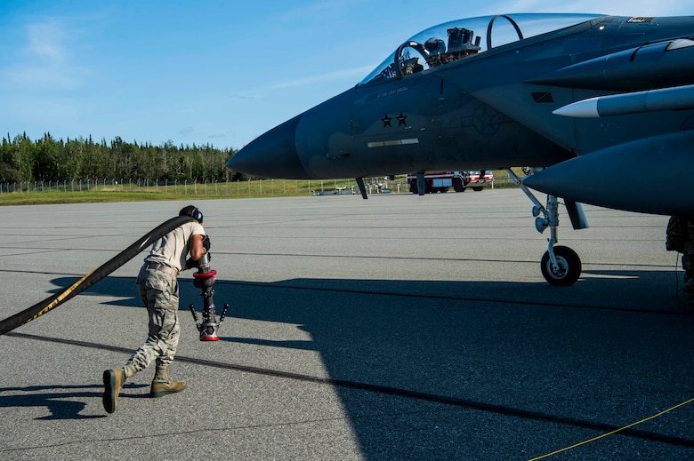 U.S. Airmen assigned to the 67th Aircraft Maintenance Unit, Kadena Air Base, Japan, prepare an F-15 Eagle for takeoff at Allen Army Airfield during Red Flag-Alaska 19-3 at Fort Greely, Alaska, Aug. 8, 2019. During the exercise, Fort Greely was used to implement agile combat employment, which allows aircraft maintainers to perform maintenance operations in remote locations with as few people as possible. (U.S. Air Force photo by Senior Airman Isaac Johnson)