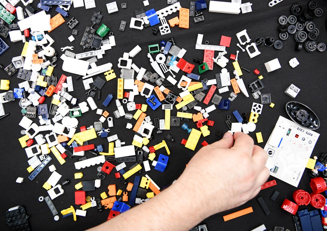 Airmen from the 90th Cyberspace Operations Squadron assemble toy bricks for their “Bricks in the Loop” display at DEF CON 27 Hacking Conference in Las Vegas, Aug. 8, 2019. “Bricks in the Loop” mimics an Air Force installation to simulate real-world cyber systems in training cyber operators. (U.S. Air Force photo by Tech. Sgt. R.J. Biermann)