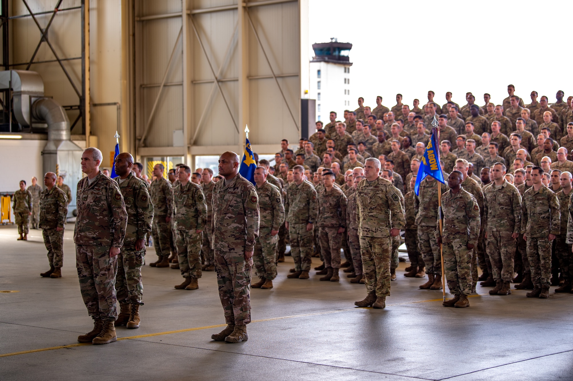 Airmen from the 435th Air Ground Operations Wing and 435th Air Expeditionary Wing stand at attention during an assumption of command ceremony at Ramstein Air Base, Germany, Aug. 16, 2019. U.S. Air Force Col. Daniel C. Clayton assumed command of the two wings from Maj. Gen. John M. Wood, Third Air Force commander. (U.S. Air Force photo by Staff Sgt. Devin Boyer)