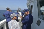 LUMUT, Malaysia (Aug 17, 2019) Capt. Bob Little, commander of the U.S. Coast Guard Cutter Stratton (WMSL 752) explains the process of a replenishment-at-sea (RAS) to a Royal Malaysian sailor as part of the at-sea phase of Maritime Training Activity (MTA) Malaysia 2019. MTA Malaysia 2019 is a continuation of 25 years of maritime engagements between the U.S. Navy and Royal Malaysian Navy serving to enhance mutual capabilities in ensuring maritime security and stability.