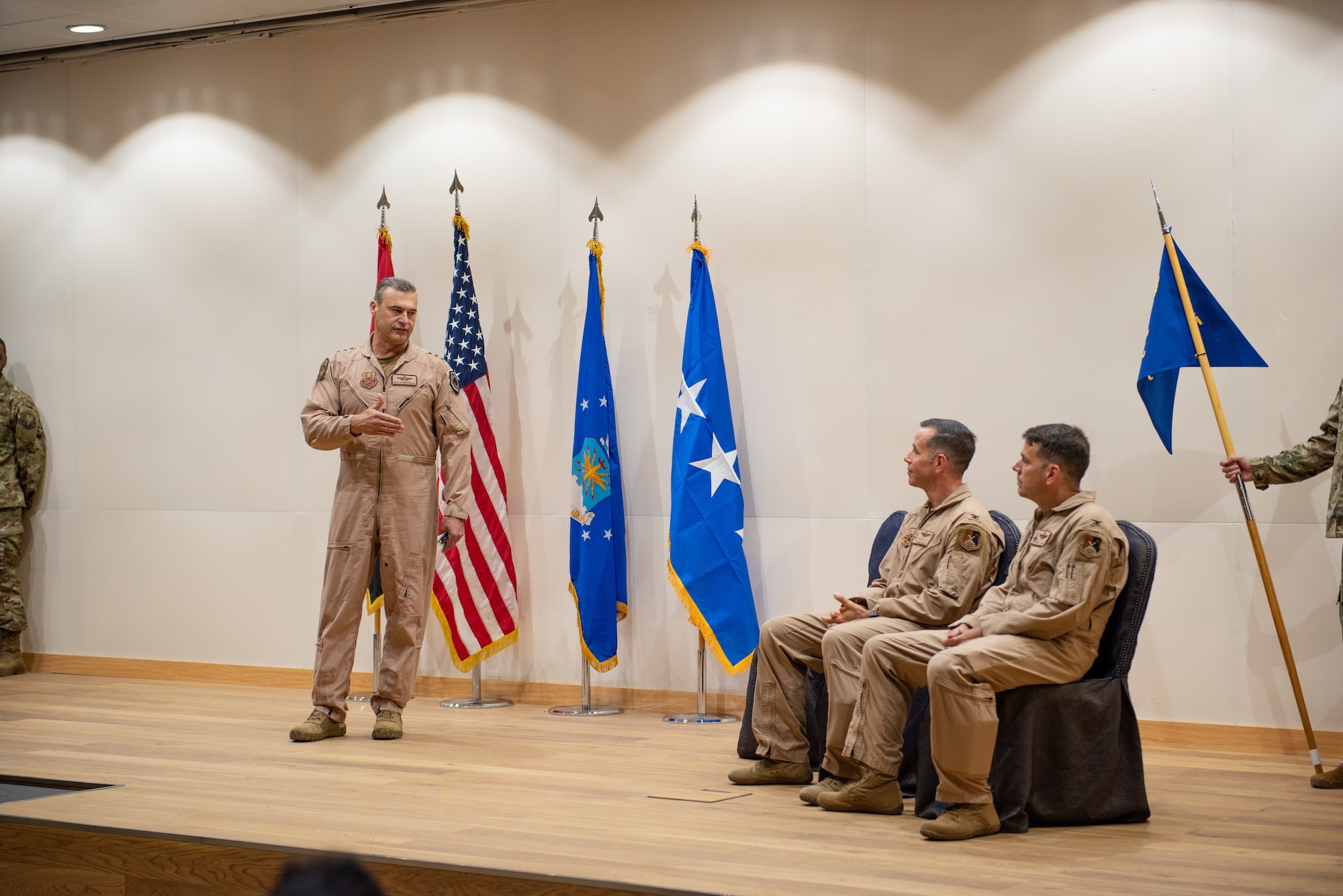 Lt. Gen. Joseph T. Guastella, U.S. Air Force Central Command commander, speaks to Col. Jason Hokaj and Col. Thomas Wolfe during the Air Warfare Center change of command ceremony June 19, 2019, at Al Dhafra Air Base, United Arab Emirates.
