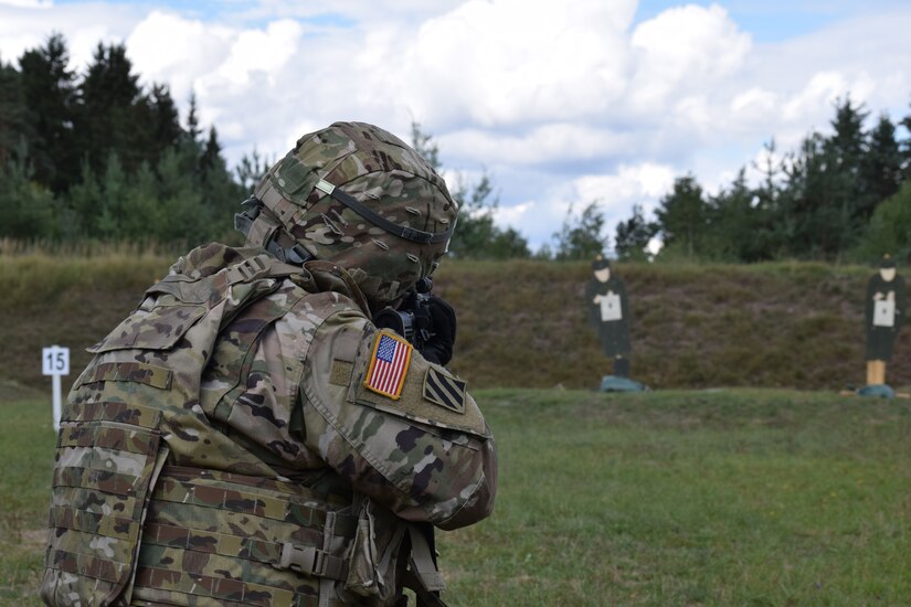 Master Sgt. Carlos Garcis, 2500th Digital Liaison Detachment acting sergeant major, fires his M4 carbine weapon during a familiarization range Aug. 14 at Grafenwoehr Training Area in Germany. The 2500th DLD is conducting basic warrior tasks and familiarizing themselves with battlefield enablers during annual training.