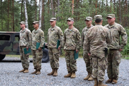 Soldiers with the 2500th Digital Liaison Detachment were recognized for their achievements and service during an awards and promotion ceremony Aug. 17 at Camp Normandy, Grafenwoehr, Germany. The recognition was the final act of outgoing commander Col. Christopher Varhola as he emphasized that his command was only possible because of the individuals who make up the unit.