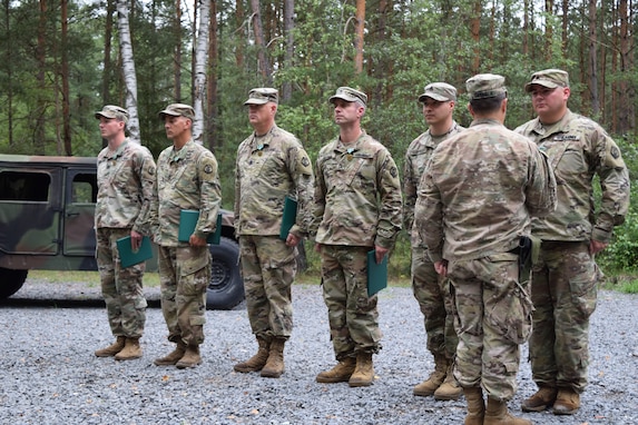 Soldiers with the 2500th Digital Liaison Detachment were recognized for their achievements and service during an awards and promotion ceremony Aug. 17 at Camp Normandy, Grafenwoehr, Germany. The recognition was the final act of outgoing commander Col. Christopher Varhola as he emphasized that his command was only possible because of the individuals who make up the unit.