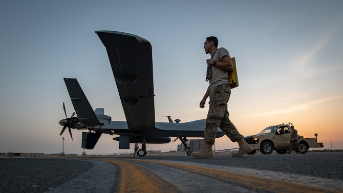 Maintainers with the 386th Expeditionary Aircraft Maintenance Squadron tow a U.S. Air Force MQ-9 Reaper remotely piloted aircraft into position for an engine test prior to Intelligence, Surveillance, and Reconnaissance operations at Ali Al Salem Air Base, Kuwait, July 23, 2019. Reaper’s are maintained, launched and recovered from deployed locations, but are remotely operated from bases in the United States during ISR operations around the world. (U.S. Air Force Photo by Tech. Sgt. Michael Mason, tail number obscured for operational security)