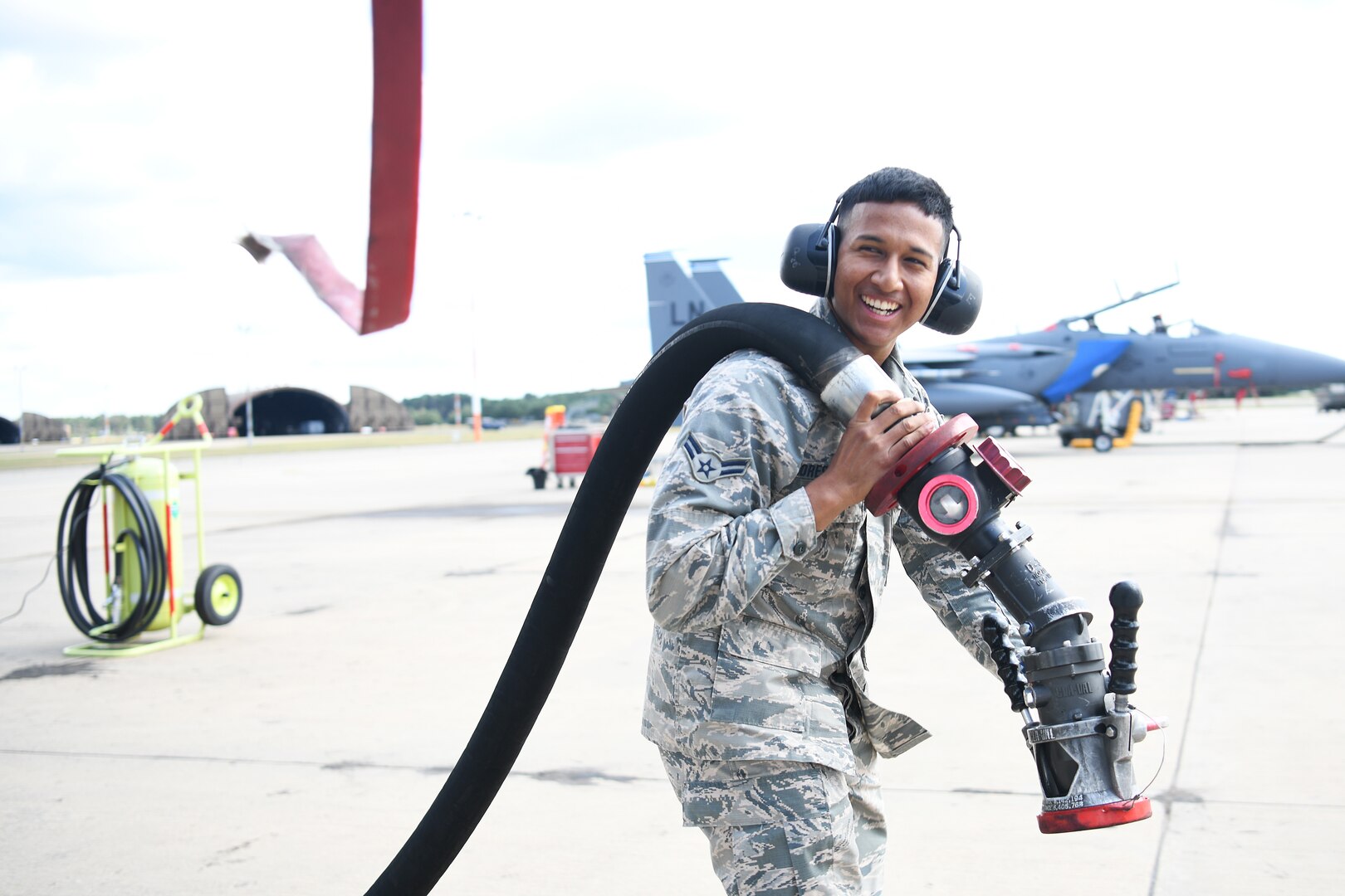 U.S. Air Force Airman 1st Class Christopher Flores-Rivera, 48th Logistics Readiness Squadron fuels distribution operator apprentice, retrieves a fuel line after assisting the refueling of an F-15E Strike Eagle at Royal Air Force Lakenheath, England, Aug. 13, 2019. Fuels Management Flight Airmen are trained and certified to fuel all assets assigned to the Liberty Wing and in charge of six million gallons of fuel to maintain facilities its supporting agencies. (U.S. Air Force photo by Airman 1st Class Shanice Williams-Jones)