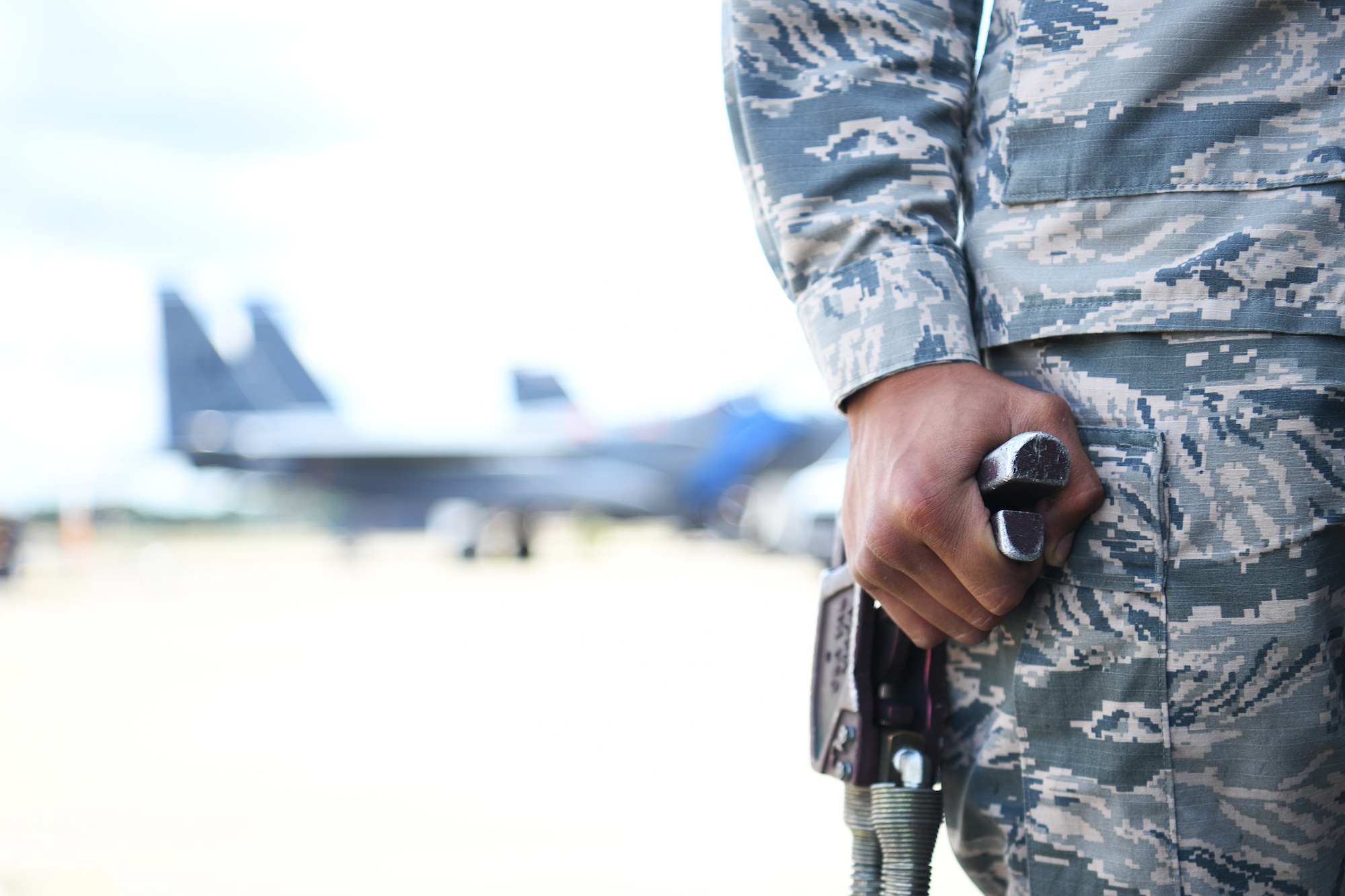 U.S. Air Force Airman 1st Class Christopher Flores-Rivera, 48th Logistics Readiness Squadron fuels distribution operator apprentice, monitors a fuel line on the flightline at Royal Air Force Lakenheath, England, Aug. 13, 2019. The Fuels Management Flight acquires, manages, distributes and maintains the fuel necessary to ensure aircraft from assigned to the 48th Fighter Wing are ready to fly. (U.S. Air Force photo by Airman 1st Class Shanice Williams-Jones)