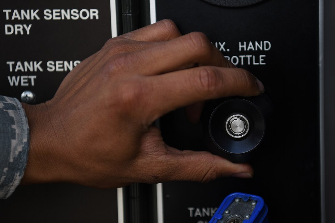 U.S. Air Force Airman 1st Class Christopher Flores-Rivera, 48th Logistics Readiness Squadron fuels distribution operator, monitors a fuel line on the flightline at Royal Air Force Lakenheath, England, Aug. 13, 2019. The Fuels Management Flight acquires, manages, distributes and maintains the fuel necessary to ensure aircraft from assigned to the 48th Fighter Wing are ready to fly. (U.S. Air Force photo by Airman 1st Class Shanice Williams-Jones)