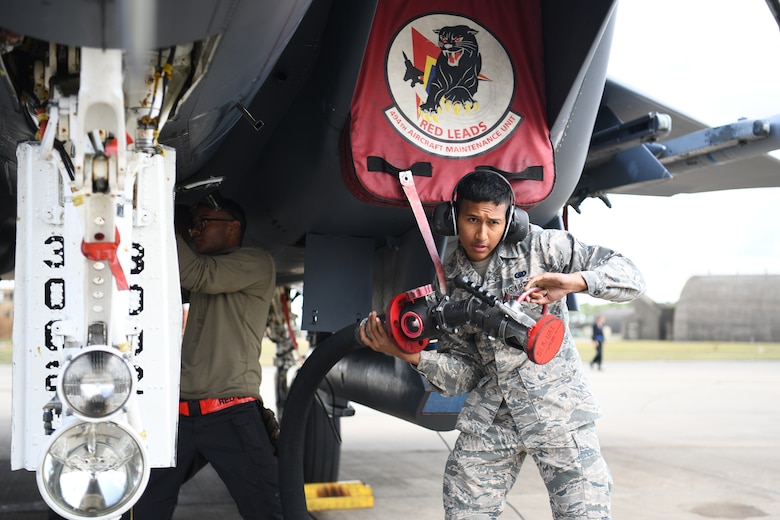 U.S. Air Force Airman 1st Class Christopher Flores-Rivera, 48th Logistics Readiness Squadron fuels distribution operator apprentice, retrieves a fuel line after assisting the refueling of an F-15E Strike Eagle at Royal Air Force Lakenheath, England, Aug. 13, 2019. The Fuels Management Flight acquires, manages, distributes and maintains the fuel necessary to ensure aircraft from assigned to the 48th Fighter Wing are ready to fly. (U.S. Air Force photo by Airman 1st Class Shanice Williams-Jones)