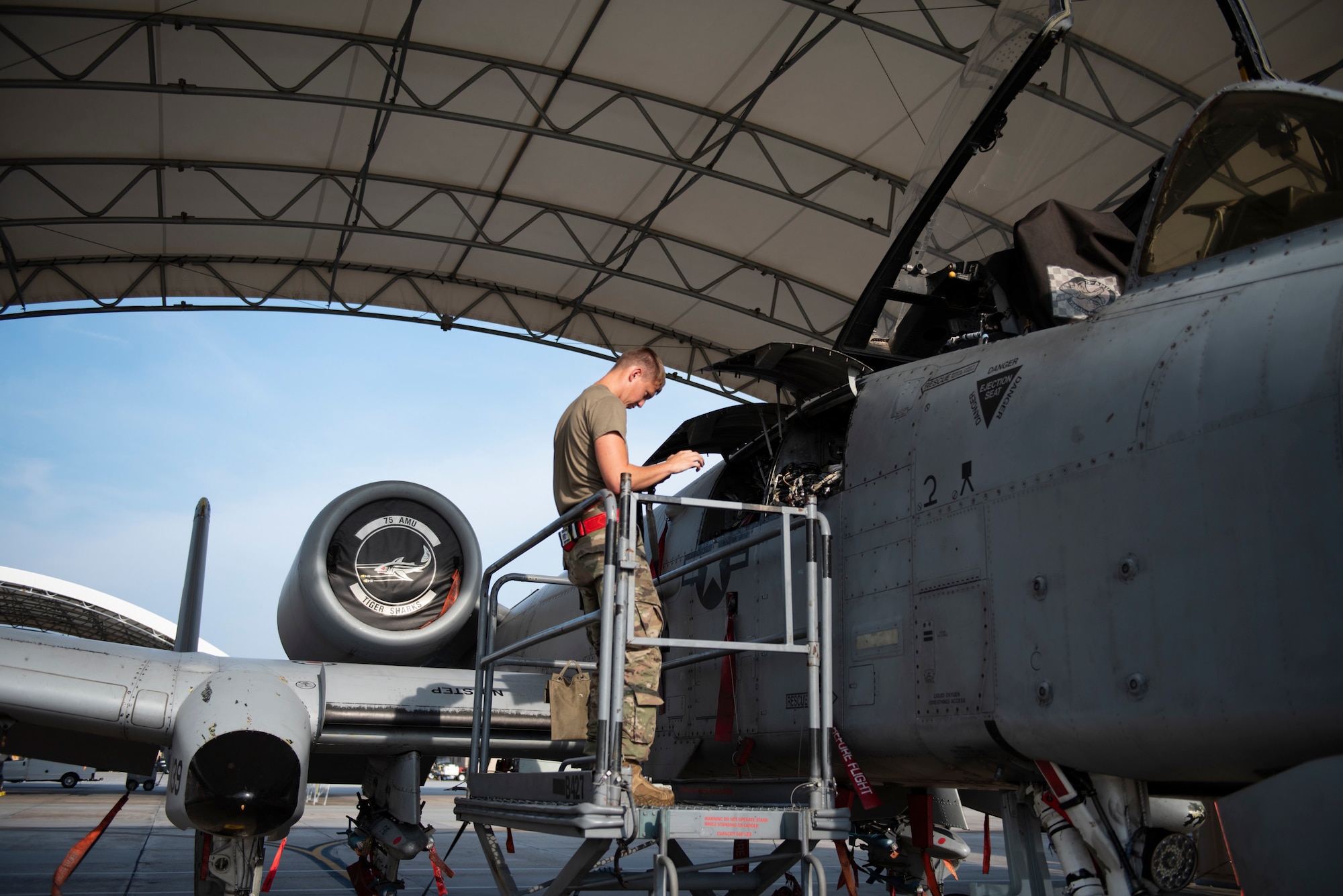 Airman 1st Class Tanner Giroux, 75th Aircraft Maintenance Unit (AMU) avionics technician, reads a technical order before beginning maintenance on an A-10C Thunderbolt II, Aug. 8, 2019, at Moody Air Force Base, Ga. The 75th AMU is responsible for the upkeep and maintenance of the Air Force’s largest operational A-10C Thunderbolt II fighter group. (U.S.  Air Force photo by 2nd Lt. Kaylin P. Hankerson)