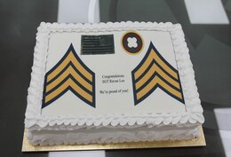 Sgt. Ravan Lee, 184th Sustainment Command, receives a cake following her promotion ceremony at Camp Arifjan, Kuwait, Aug. 14, 2019.