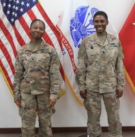 Sgt. Ravan Lee, 184th Sustainment Command, stands next to her step-mother, Lt. Col. Annie Merle Lee, 184th Sustainment Command, during Ravan's promotion ceremony to sergeant at Camp Arifjan, Kuwait, Aug. 14, 2019.