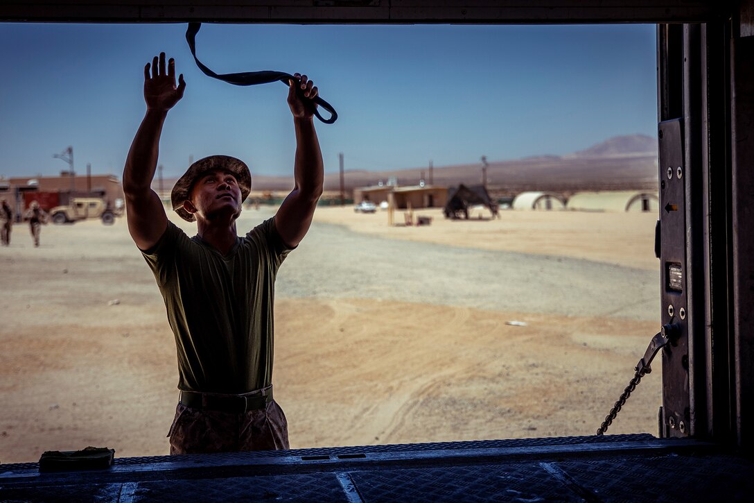 A Marine opens a trailer.