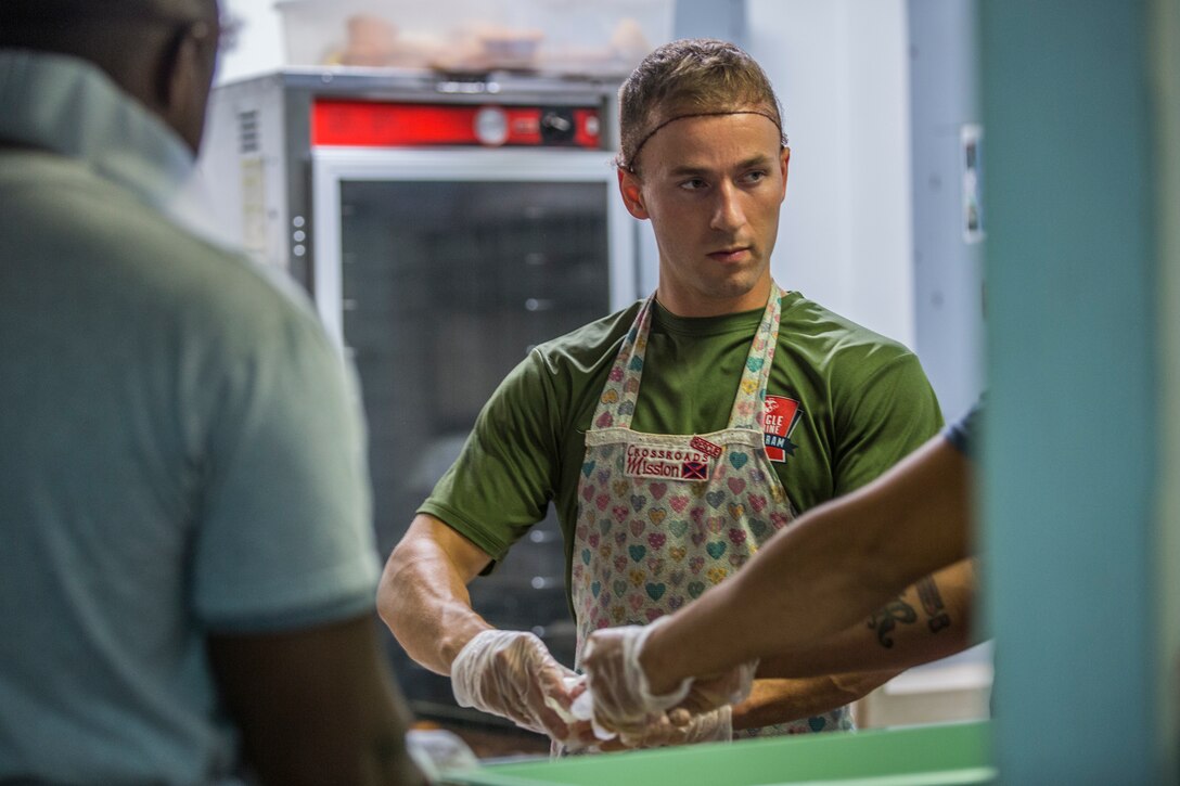 U.S. Marines stationed at Marine Corps Air Station (MCAS) Yuma, participate in the MCAS Yuma Single Marine Program's (SMP) volunteer event at the Crossroads Mission in Yuma, Ariz., August 10, 2019. The Marines served food, cleaned, and prepared food for the mission. (U.S. Marine Corps photo by Cpl. Sabrina Candiaflores)