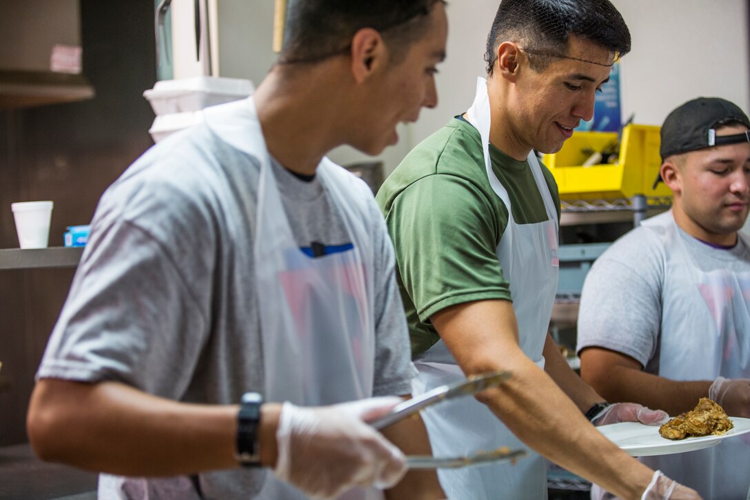 U.S. Marines stationed at Marine Corps Air Station (MCAS) Yuma, participate in the MCAS Yuma Single Marine Program's (SMP) volunteer event at the Crossroads Mission in Yuma, Ariz., August 10, 2019. The Marines served food, cleaned, and prepared food for the mission. (U.S. Marine Corps photo by Cpl. Sabrina Candiaflores)