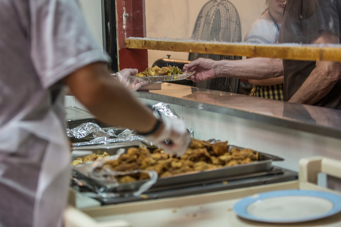 U.S. Marines stationed at Marine Corps Air Station (MCAS) Yuma, participate in the MCAS Yuma Single Marine Program's (SMP) volunteer event at the Crossroads Mission in Yuma, Ariz., August 10, 2019. The Marines served food, cleaned, and prepared food for the mission. (U.S. Marine Corps photo by Cpl. Sabrina Candiaflores)