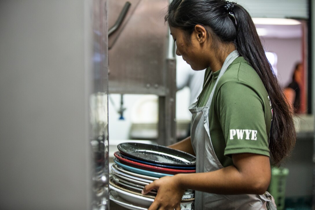 U.S. Marines stationed at Marine Corps Air Station (MCAS) Yuma, participate in the MCAS Yuma Single Marine Program's (SMP) volunteer event at the Crossroads Mission in Yuma, Ariz., August 10, 2019. The Marines served food, cleaned, and prepared food for the mission. (U.S. Marine Corps photo by Cpl. Sabrina Candiaflores)