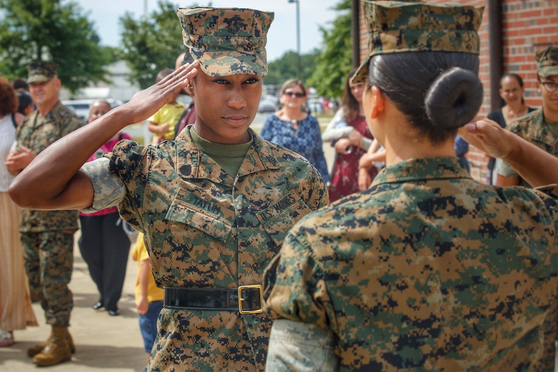 A Marine salutes another Marine.