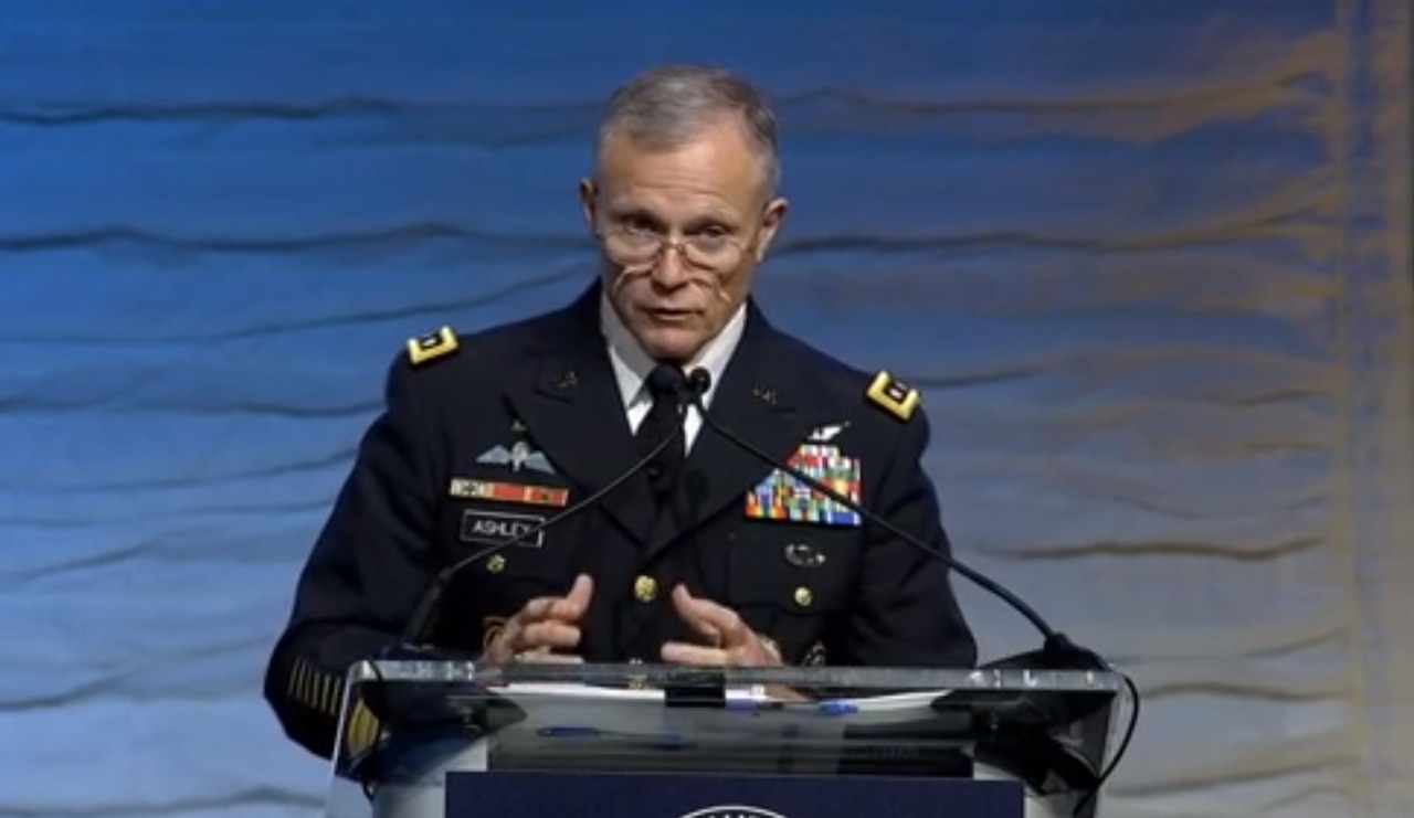 Man speaks at lectern.