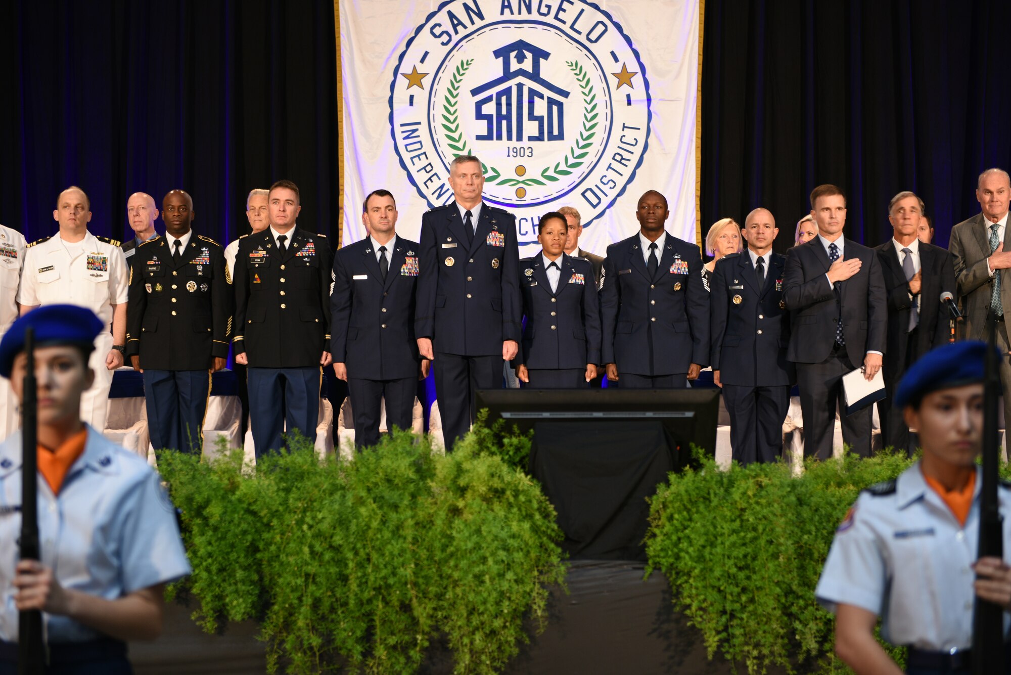 Goodfellow Air Force Base leadership stands for the National Anthem during the San Angelo Independent School District’s annual Convocation at the Foster Communications Coliseum in San Angelo, Texas August 15, 2019. Leadership from Goodfellow attends this event to strengthen it’s relationship with the community and to meet individuals from the local school district. (U.S. Air Force photo by Airman 1st Class Robyn Hunsinger/Released)