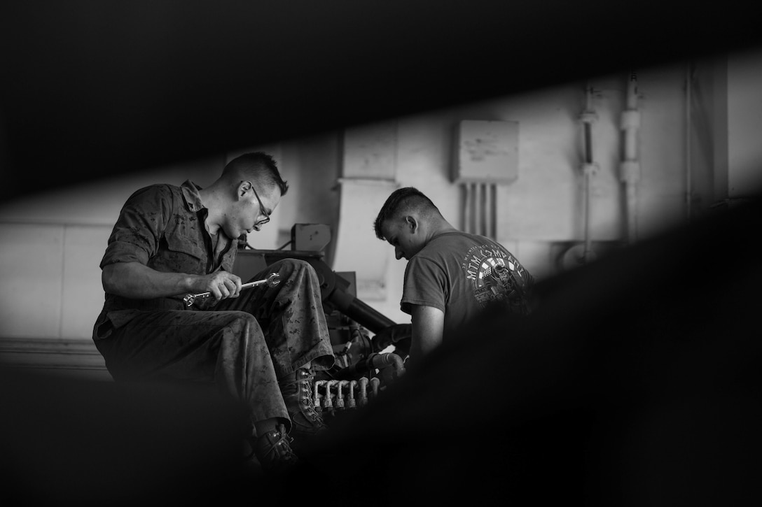 U.S. Marine Corps Cpl. Ian Masoner, left, and Lance Cpl. Logan Pumroy perform corrective maintenance on a manifold assembly on Camp Kinser, Okinawa, Japan, August 16, 2019. The manifold assembly is part of a retrieval system that is attached to a Logistical Vehicle System Replacement. The retrieval system is able to lift and transport large vehicles such as 7-tons and other LVSR’s. Masoner, a native of Santa Cruz, California, is a motor transportation technician with Motor Transport Maintenance Company, 3rd Maintenance Battalion, 3rd Marine Logistics Group. Pumroy, a native of Elbert, Colorado, is a motor transportation technician with MTM Co., 3rd Maint. Bn., 3rd MLG.