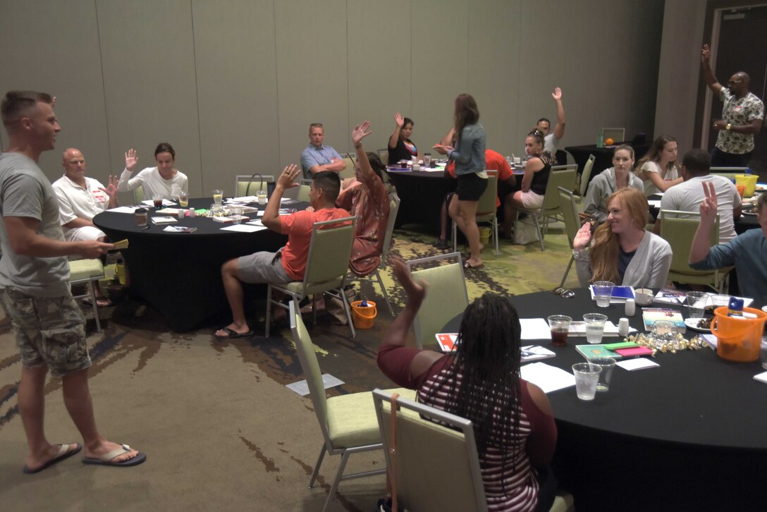 Tech. Sgt. Noah Stamps, 325th Fighter Wing Chaplain Corps superintendent, asks a group question at a marriage retreat seminar Aug. 17 -18, 2019, in Fort Walton, Fla. Approximately 20 couples attended the seminar and discussed topics including expectations versus reality, balancing work-life and children, being healthy together, forgiveness, finances, navigating the trials of changing environments, and in some cases, rebuilding from the 2018 Hurricane Michael. (U.S. Air Force photo by Staff Sgt. Magen M. Reeves)