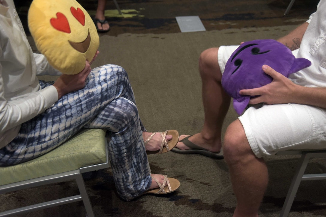 Airmen from the 325th Fighter Wing and their spouses participate in a communication activity at a marriage retreat seminar Aug. 17 -18, 2019, in Fort Walton, Fla. Participants were encouraged to describe to their significant other an experience or a feeling they had determined by which emoji they were given. (U.S. Air Force photo by Staff Sgt. Magen M. Reeves)