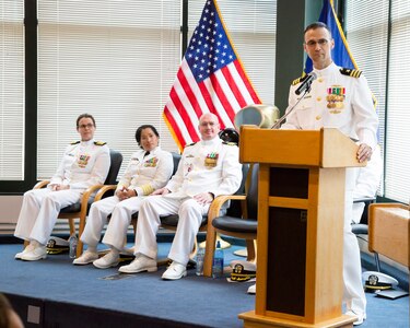 Cmdr. Aaron Cudray speaks to those in attendance at the Puget Sound Naval Shipyard Detachment Everett change of charge ceremony held August 16 at Naval Station Everett. Other members of the official party include (from left) Capt. Dianna Wolfson, commander, Puget Sound Naval Shipyard & Intermediate Maintenance Facility, Capt. Ginalyn Harrell, deputy commander, Northwest Regional Maintenance Facility, and Cmdr. Mark Schuchmann, outgoing office in charge, Puget Sound Naval Shipyard & Intermediate Maintenance Facility Detachment Everett.