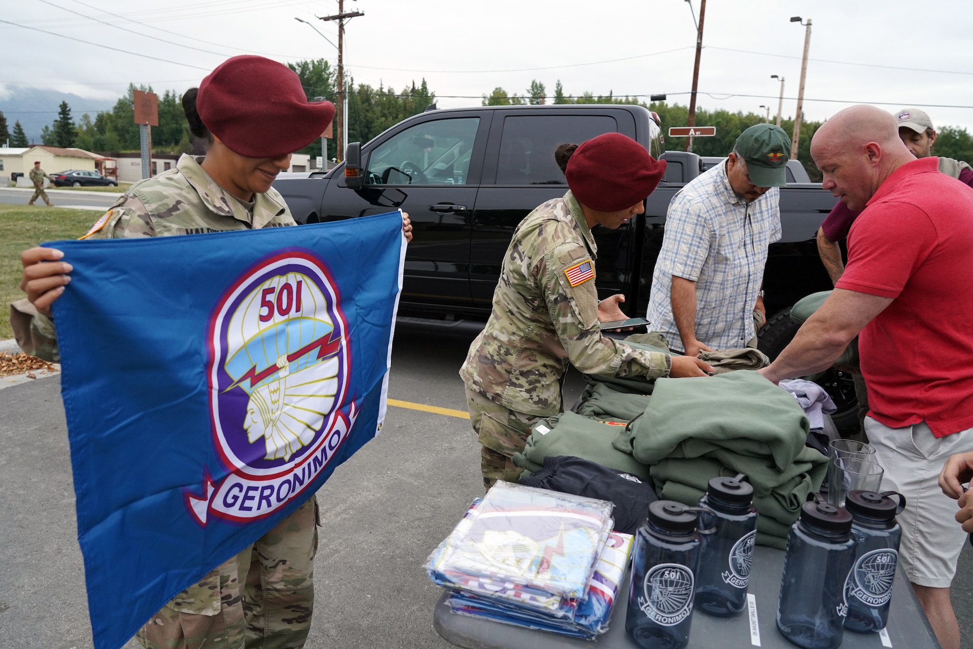 Army 1st Lt. Frances Maldonado, of San Antonio, Texas, unfolds a battalion flag as paratroopers assigned to the 1st Battalion, 501st Parachute Infantry Regiment, 4th Infantry Brigade Combat Team (Airborne), 25th Infantry Division, U.S. Army Alaska, veterans of the unit, dependents, and honored guests gather for 'Geronimo Week' festivities on Joint Base Elmendorf-Richardson, Alaska, Aug. 14, 2019, celebrating the unit's lineage. The regiment was activated on Nov. 15, 1942, at Camp Toccoa, Ga., served with distinction in World War II, the Cold War, Vietnam, as well as the Global War on Terror and continues to uphold the high standards expected of an airborne unit in peacetime duties and on the field of battle.