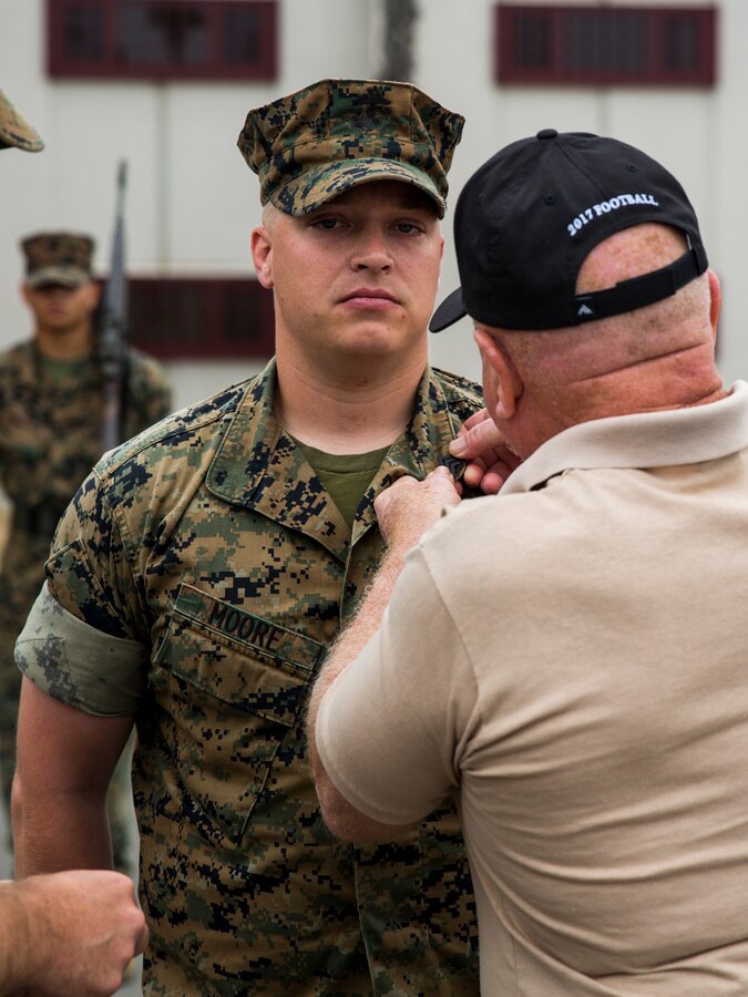 U.S. Marine Sgt. Michael Moore, an intelligence specialist with the 13th Marine Expeditionary Unit, is promoted at Camp Pendleton, Calif. August 1, 2019. The Marines and Sailors of the 13h MEU continue to prepare themselves in garrison in between deployments. (U.S. Marine Corps photo by Cpl. A. J. Van Fredenberg)