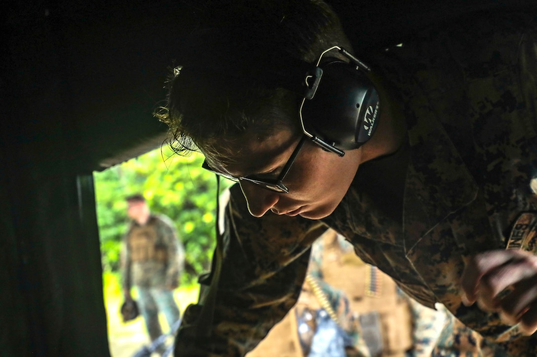 U.S. Marine Corps Cpl. William Baker prepares ammunition during a machine gun range on Range 7, Camp Hansen, Okinawa, Japan, June 20, 2019. During the range, Marines with Communications Company, Combat Logistics Regiment 37, 3rd Marine Logistics Group, trained to improve field communications skills while employing M249 light machine guns, M240B medium machine guns and .50 caliber machine guns. Baker, a native of Bowling Green, Kentucky, is the ammunition chief for CLR-37, 3rd MLG. (U.S. Marine Corps photo by Cpl. Joshua Pinkney)