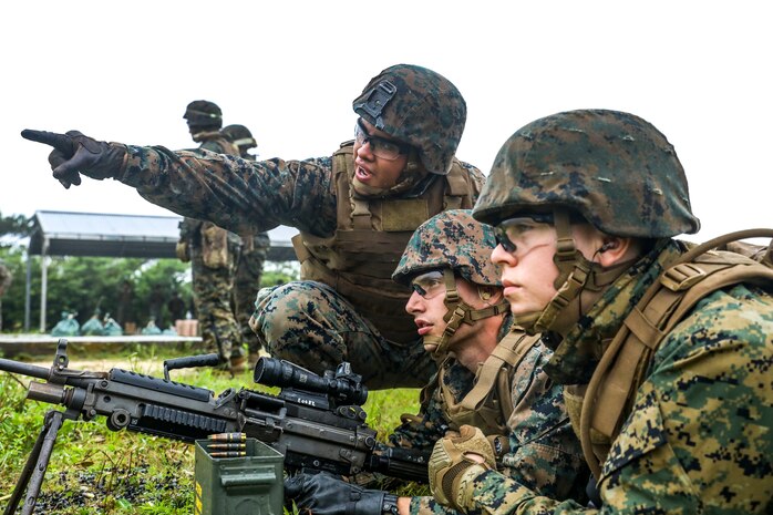 U.S. Marine Corps Lance Cpl. Bryan Mata, left, instructs Marines during a machine gun range on Range 7, Camp Hansen, Okinawa, Japan, June 20, 2019. During the range, Marines with Communications Company, Combat Logistics Regiment 37, 3rd Marine Logistics Group, trained to improve field communications skills while employing M249 light machine guns, M240B medium machine guns and .50 caliber machine guns. Mata, a native of Kearns, Utah, is a weapons instructor with Tactical Readiness and Training Platoon, CLR-37, 3rd MLG. (U.S. Marine Corps photo by Cpl. Joshua Pinkney)